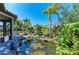 Lush backyard pond with mature landscaping and rock accents at 4908 Tivoli Run, Bradenton, FL 34211