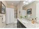 Well-lit bathroom with a shower and tub, vanity, and a decorative granite countertop at 4908 Tivoli Run, Bradenton, FL 34211
