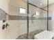Luxury bathroom featuring a seamless glass shower, decorative tile accents, and built-in bench at 4908 Tivoli Run, Bradenton, FL 34211