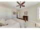 Calm bedroom featuring natural light, a ceiling fan, and neutral decor with wood accents at 4908 Tivoli Run, Bradenton, FL 34211