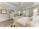 Inviting bedroom featuring tray ceilings, hardwood floors, plantation shutters, and relaxing ambience at 4908 Tivoli Run, Bradenton, FL 34211