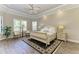 Bright bedroom with hardwood floors, tray ceiling, plantation shutters, and an abundance of natural light at 4908 Tivoli Run, Bradenton, FL 34211
