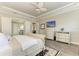 Comfortable bedroom with a tray ceiling, hardwood floors, media center, and plantation shutters at 4908 Tivoli Run, Bradenton, FL 34211