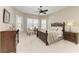 Serene bedroom with neutral tones, natural lighting, and a detailed wood bed frame at 4908 Tivoli Run, Bradenton, FL 34211