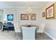 Well-lit dining area with a chandelier, round table, and modern chairs at 4908 Tivoli Run, Bradenton, FL 34211