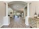 Elegant foyer with wood floors, archways, columns, and a view into the open living spaces at 4908 Tivoli Run, Bradenton, FL 34211