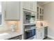 Close up of the kitchen appliances featuring stainless steel oven, microwave, and built-in wine cooler at 4908 Tivoli Run, Bradenton, FL 34211