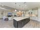 Open concept kitchen with an island and stainless steel appliances connects to the living area at 4908 Tivoli Run, Bradenton, FL 34211