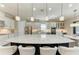 Modern kitchen featuring a large center island with quartz countertops and pendant lighting at 4908 Tivoli Run, Bradenton, FL 34211