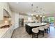 Modern kitchen featuring a large island with seating, stainless steel appliances, and pendant lighting at 4908 Tivoli Run, Bradenton, FL 34211