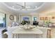 Open living room featuring a ceiling fan, neutral tones, and elegant decor at 4908 Tivoli Run, Bradenton, FL 34211