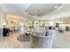 Spacious living room leading into a kitchen, with a large swivel chair and modern decor at 4908 Tivoli Run, Bradenton, FL 34211