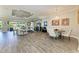 Open-concept living room featuring wood floors, a dining area, and sliding doors to outdoor space at 4908 Tivoli Run, Bradenton, FL 34211