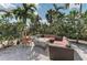Relaxing outdoor seating area with a fire pit, perfect for socializing and enjoying the tropical scenery at 4908 Tivoli Run, Bradenton, FL 34211
