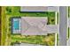 Aerial view of a well-maintained home with a private pool and neatly manicured lawn at 4975 Seafoam Trl, Bradenton, FL 34211