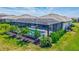 Aerial view showcasing the screened-in pool, patio area, landscaping and water view at 4975 Seafoam Trl, Bradenton, FL 34211
