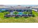 Aerial view of the pool and patio in screened enclosure with beautiful landscaping and water view at 4975 Seafoam Trl, Bradenton, FL 34211