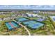 Aerial view of the recreational facilities including tennis courts, pickleball courts, pool, and basketball court at 4975 Seafoam Trl, Bradenton, FL 34211