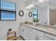 Well-lit bathroom features dual sinks, granite countertops, and decorative wreaths on the wall at 4975 Seafoam Trl, Bradenton, FL 34211