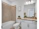 Bathroom with a tub-shower combo, granite countertop vanity, and neutral tile at 4975 Seafoam Trl, Bradenton, FL 34211