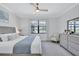 Bright bedroom boasts a ceiling fan, stylish decor, and tranquil views of the lake at 4975 Seafoam Trl, Bradenton, FL 34211