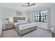 Charming bedroom featuring a ceiling fan, soft natural light, and a serene lake view at 4975 Seafoam Trl, Bradenton, FL 34211