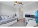 Comfortable bedroom featuring a daybed, desk, and neutral colors, with a ceiling fan at 4975 Seafoam Trl, Bradenton, FL 34211