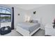 Serene bedroom with white furniture, a plush beanbag, and a view of the outdoor landscape at 4975 Seafoam Trl, Bradenton, FL 34211