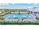 Resort-style community pool area with lounge chairs, umbrellas, and tropical landscaping at 4975 Seafoam Trl, Bradenton, FL 34211