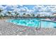 Large community pool offers a refreshing escape, complete with ample lounging and sunny skies at 4975 Seafoam Trl, Bradenton, FL 34211