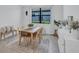 Dining room with a wooden table, woven chairs, a neutral rug, and a bright window view at 4975 Seafoam Trl, Bradenton, FL 34211