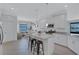 Bright kitchen with stainless steel appliances, granite countertops, a center island, and tile flooring at 4975 Seafoam Trl, Bradenton, FL 34211