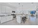 Bright kitchen with stainless steel appliances, granite countertops, a center island, and tile flooring at 4975 Seafoam Trl, Bradenton, FL 34211