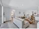 Bright and airy living room with a sectional sofa, wood accents, and a view into the kitchen area at 4975 Seafoam Trl, Bradenton, FL 34211