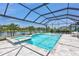 Beautiful pool and spa area under a screened enclosure overlooking a tranquil pond at 4975 Seafoam Trl, Bradenton, FL 34211