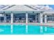 View of the neighborhood pool with chairs and tables available for residents, all under a covered patio at 4975 Seafoam Trl, Bradenton, FL 34211