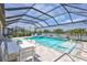 Inviting screened-in pool with dining and lounge areas and picturesque lake view at 4975 Seafoam Trl, Bradenton, FL 34211