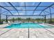 Stunning pool and spa offer serene lake views under a screened enclosure, perfect for relaxation at 4975 Seafoam Trl, Bradenton, FL 34211