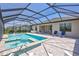 Covered pool with spa and inviting patio with plenty of room for relaxing and entertaining at 4975 Seafoam Trl, Bradenton, FL 34211