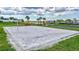 Enjoy a fun game of sand volleyball on the community court, surrounded by lush landscaping and palm trees at 4975 Seafoam Trl, Bradenton, FL 34211