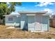 Back of house featuring a chair, white door, and turquoise exterior at 5214 11Th S Ave, Gulfport, FL 33707