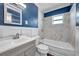 Stylish bathroom with blue walls, marble-tiled shower, modern sink, and a large mirror at 5214 11Th S Ave, Gulfport, FL 33707