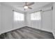 Bright, well-lit bedroom with neutral walls, wood-look floors, and sheer curtains for a clean, modern look at 5214 11Th S Ave, Gulfport, FL 33707