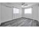 Bright bedroom with wood-look floors, sheer curtains, and ample natural light from large windows at 5214 11Th S Ave, Gulfport, FL 33707