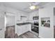 Clean, white kitchen with stainless steel appliances, granite countertops, and a view into the living area at 5214 11Th S Ave, Gulfport, FL 33707