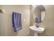 Powder room with pedestal sink, oval mirror, and neutral wall color at 5403 Mang Pl, Sarasota, FL 34238