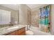 Cozy bathroom with a granite vanity, white sink, and shower-tub combination at 5403 Mang Pl, Sarasota, FL 34238
