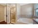 Bright bathroom showcasing a glass-enclosed shower and soaking tub at 5403 Mang Pl, Sarasota, FL 34238
