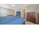 Bright bedroom featuring television, dressers, and an adjacent bathroom at 5403 Mang Pl, Sarasota, FL 34238