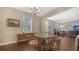 Dining room with a round wooden table, chairs, and sliding glass doors to the backyard at 5403 Mang Pl, Sarasota, FL 34238